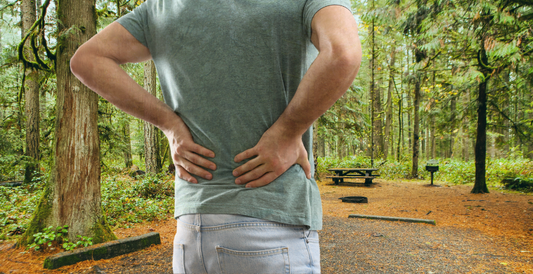 Image of a person with a sore back while camping